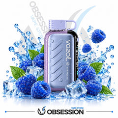 A Vozel Blue Razzle disposable vape device in lavender purple and black, surrounded by fresh blue raspberries, mint leaves, ice cubes, and water splashes on a white background with Obsession branding.