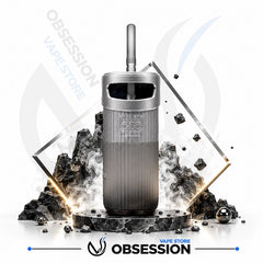 A Obsession OZO vape device in Grey and dark gray, displayed with a black mouthpiece, surrounded by stylized black rocks, smoke effects, and geometric gold frames on a white background with Obsession branding.