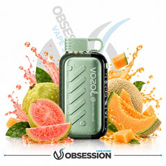 A mint green Vozol Quma Melon disposable vape device surrounded by fresh fruit slices, guavas, and melon, with orange juice splashes and a white background. The Obsession store logo is visible at the bottom.