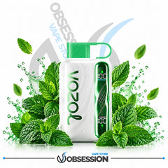A white VOOZ vape device with a green mouthpiece and a green side display panel, surrounded by fresh mint leaves and water droplets on a white background. The brand name 'VOOZ' is printed vertically on the device, and 'Obsession Vape Store' is visible as a watermark and logo.