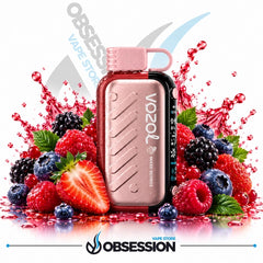 A Vozol Mini Series vape device with a metallic rose gold body and a black side panel, surrounded by fresh berries and a red liquid splash on a white background with Obsession branding.
