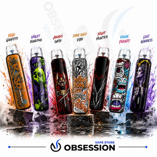 Six disposable vape devices with colorful graphic designs are lined up on a reflective surface against a white background with paint splatters. The devices feature various horror-themed illustrations including skulls, zombies, and a ghost.