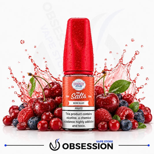 Berry Blast Salt 30ml By Dinner Lady.webp shows a Dinner Lady Berry Blast Salts vape juice bottle with a vibrant red cap, surrounded by an abundant mix of fresh berries (including glossy red cherries with green stems and leaves, raspberries, blueberries, and cranberries), and dynamic red liquid splashes on a white background.
