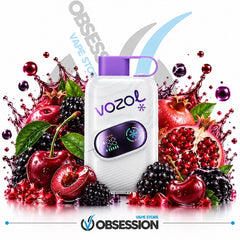 A white Vozol vape device with a purple mouthpiece and digital screen, surrounded by fresh fruit splashes including cherries, blackberries, pomegranate, and green leaves on a white background with Obsession and Vapo Store branding.