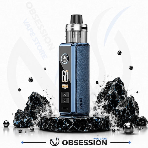 A blue and black vape device with a textured blue side panel and a digital display, standing on a black marble pedestal with dramatic black rocks and water splashes against a white background. The Obsession Vapec Store brand name is visible.