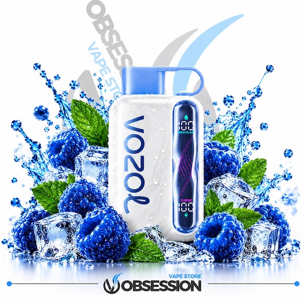 A white Vozol disposable vape device with a blue mouthpiece and digital screen, surrounded by blue raspberries, ice cubes, and green mint leaves with water splashes, on a white background with Obsession branding.