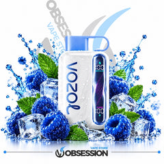 A white Vozol disposable vape device with a blue mouthpiece and digital screen, surrounded by blue raspberries, ice cubes, and green mint leaves with water splashes, on a white background with Obsession branding.