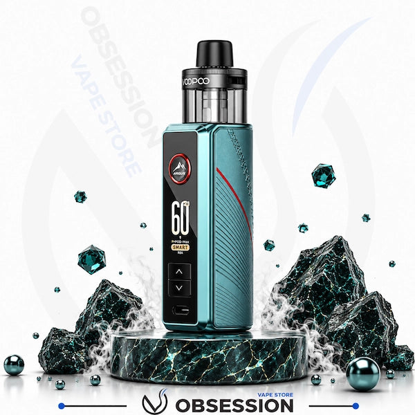 A vape device with a metallic teal and black body, a digital display screen, and a clear tank, presented on a dark marble pedestal with floating gemstone props against a white background with 'OBSESSION VAPE STORE' watermarks.