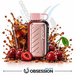 A Vozol Cherry Cola disposable vape device in metallic rose gold, styled with a glass of iced cola and fresh cherries surrounded by dynamic liquid splashes on a white background. The Obsession Vape Store logo is visible at the bottom.