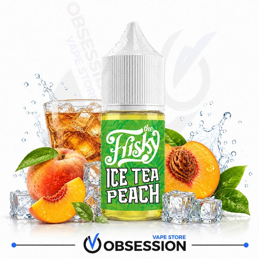 A bottle of 'The Frisky Ice Tea Peach' e-liquid by Obsession Vape Store, styled with fresh peaches, mint leaves, ice cubes, and a glass of iced tea on a white background with water splashes.