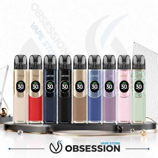 A lineup of ten Wemax vape devices in various colors, displayed on a black stand with a circular base. The devices feature a metallic body, a black top, and a digital screen showing '30'.
