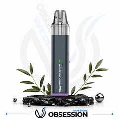 A dark gray disposable vape device labeled 'MADNESS VIBE' with a purple base, displayed on a black marble block with decorative green leaves and small metallic spheres. The background is white with a faint 'OBSESSION VAPE STORE' watermark, and the 'OBSESSION VAPE STORE' logo is displayed at the bottom.