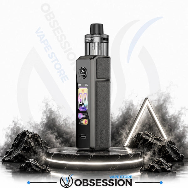 A Obsession vape device with a textured dark gray body and a clear tank, standing on a glowing circular platform with stylized smoke, rocks, and a geometric light frame against a white background with Obsession branding.