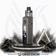 A Obsession vape device with a textured dark gray body and a clear tank, standing on a glowing circular platform with stylized smoke, rocks, and a geometric light frame against a white background with Obsession branding.