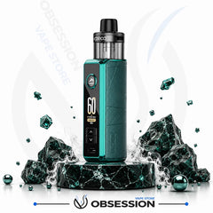 A vape device with a dark teal and black body, standing on a black marble pedestal with decorative rocks and smoke effects. The device has a digital display showing '60' and the brand 'VOPOCO' is visible on the tank.