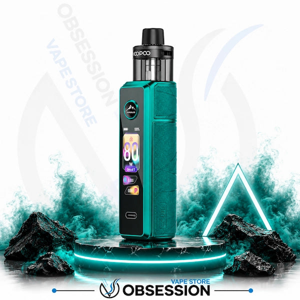 A teal and black VoOPOO vape device with a digital display screen, standing on a black marble pedestal with glowing blue neon effects, rocks, and smoke against a white background with OBSESSION VAPE STORE watermarks.