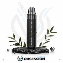 A black Vaporesso X2 vape device with a clear mouthpiece, standing upright on a dark stone base with decorative green leaves and metallic spheres against a white background. The Obsession Vape Store logo is visible at the bottom.