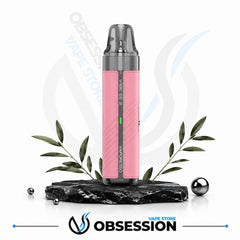 A pink and gray Vaporesso Vape SE 2 disposable vape device displayed on a black marble base with decorative green leaves and metallic spheres, against a white background with Obsession Vape Store branding.