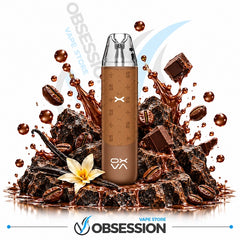 A brown disposable vape device with a monogram pattern stands centered on a pile of chocolate chunks, coffee beans, vanilla beans, and a flower, with chocolate splashes and droplets around it. The background is white with Obsession Vape Store branding.