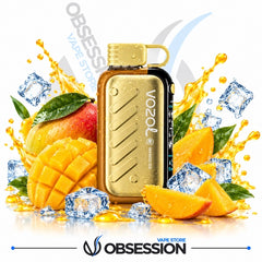 A gold Vozol Nano Ice vape device is centered against a white background, surrounded by a stylized fruit and ice splash arrangement including mango slices, a mango, ice cubes, and golden liquid splashes. The Obsession Vape Store logo appears at the bottom, and the Vozol brand name is printed on the device.