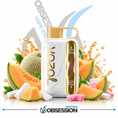 A white VOZOL vape device with gold accents and a digital display, surrounded by melon slices, cantaloupe, mint leaves, and pink and white sugar cubes, with a water-droplet effect. The background is white with a faint Obsession logo and a blue swoosh.