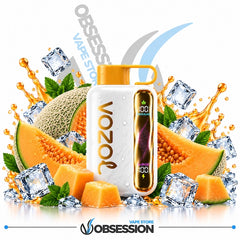 A white VOZOL vape bottle with a gold cap and a gold side panel, surrounded by melon slices, cantaloupe, mint leaves, ice cubes, and orange juice splashes on a white background. The brand name 'OBSESSION' is visible at the bottom and in the background.