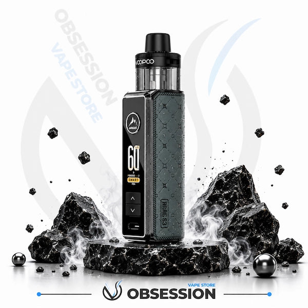 A black and dark gray VooPoo vape device stands on a pedestal surrounded by black rocks and floating charcoal pieces, with Obsession VapeStore branding in the background.