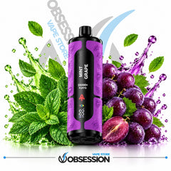 A purple and black disposable vape device labeled 'MINT GRAPE' stands centered between green mint leaves and purple grape graphics with water splashes on a white background. The Obsession Vape Store logo appears at the bottom.