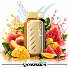 A Vozol Fresh Mango Watermelon vape device in a metallic gold finish with a black side accent, surrounded by fresh fruit slices, peaches, and watermelon with liquid splashes on a white background. The Obsession Vape Store logo is visible at the bottom.
