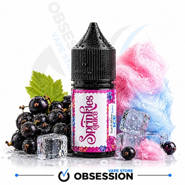 A bottle of Obsession Sprinkles Juice e-liquid centered on a white background, surrounded by black berries, ice cubes, a green leaf, and pink-and-blue cotton candy. The bottle label reads 'Sprinkles Juice' and 'Salt Life flavor.