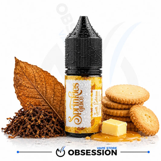 A bottle of Obsession Sparkles Glucose e-liquid, Salt Edition, styled with a dried tobacco leaf, tobacco leaves, round biscuits, and a pat of butter on a white background with a brand watermark.