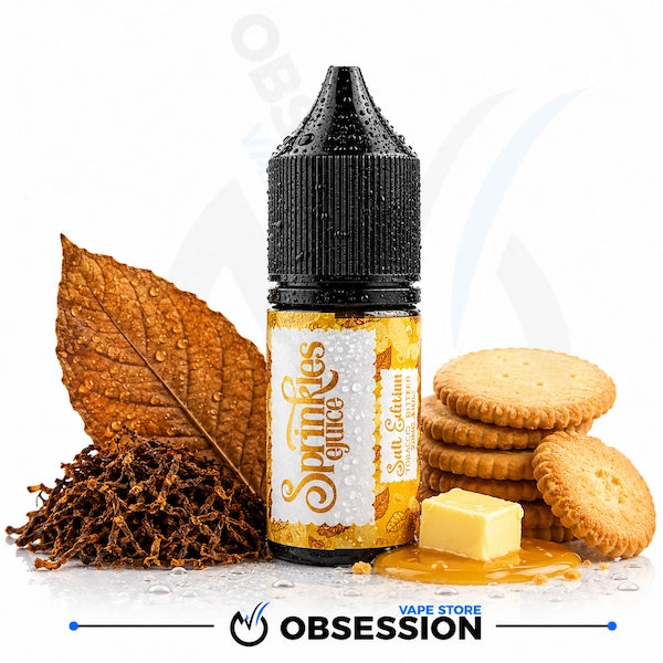 A bottle of Obsession Sparkles Glucose e-liquid, Salt Edition, styled with a dried tobacco leaf, tobacco leaves, round biscuits, and a pat of butter on a white background with a brand watermark.