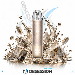 A metallic gold disposable vape device stands upright in the center, surrounded by dramatic ice cubes and water splashes on a white background. The Obsession VAPE Store logo is visible in the background and at the bottom.