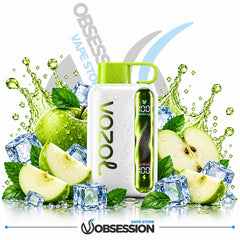 A white VOOZOL vape device with a bright green mouthpiece and side panel, surrounded by green apples, apple slices, mint leaves, and ice cubes on a white background with water splashes. The Obsession brand logo is visible at the bottom.