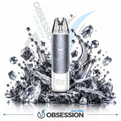 A disposable vape device with a brushed silver and white body stands upright in front of a dramatic splash of ice and water on a white background. The Obsession brand logo is visible at the bottom, and 'OBSESSION VAPE STORE' appears as a watermark in the background.