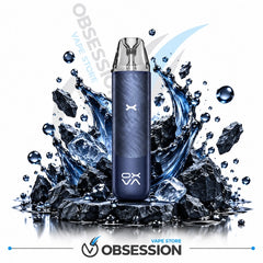 A dark blue disposable vape device with a textured finish stands upright in a stylized splash of water and ice cubes on a white background, with the Obsession Vape Store logo visible.
