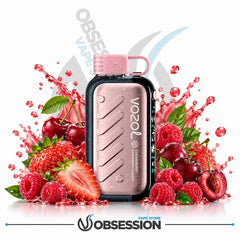 A Vozol disposable vape device in a metallic rose gold finish with a pink mouthpiece, surrounded by fresh strawberries, raspberries, cherries, and water splashes on a white background with Obsession branding.