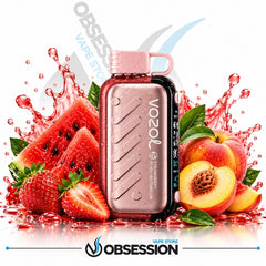 A Vozol disposable vape device in a metallic rose gold finish with a black side panel, surrounded by fresh fruit slices including watermelon, strawberries, and peaches with red syrup splashes. The background is white with a faint watermark and the Obsession VAPE Store logo at the bottom.
