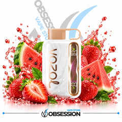 A white VOZOL vape device with a beige mouthpiece and a clear side window showing a purple coil, surrounded by fresh watermelon slices, strawberries, and green leaves with red fruit splashes on a white background. Obsession branding is visible.