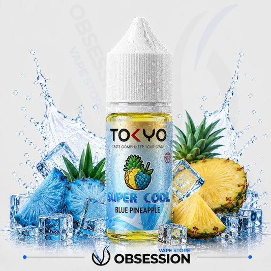 TOKYO Super Cool Blue Pineapple vape juice bottle with pineapple slices and ice cubes on a light gray background.