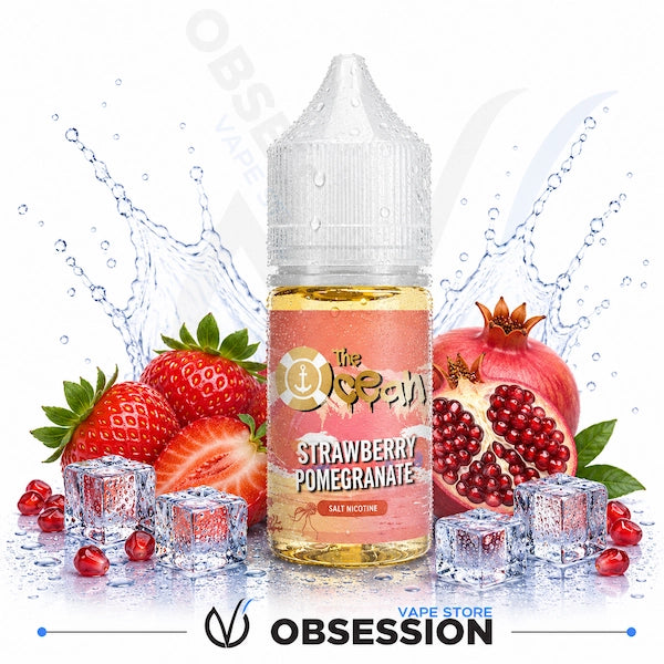 Vape juice bottle with strawberry and pomegranate flavor surrounded by fruits and ice cubes on a white background.