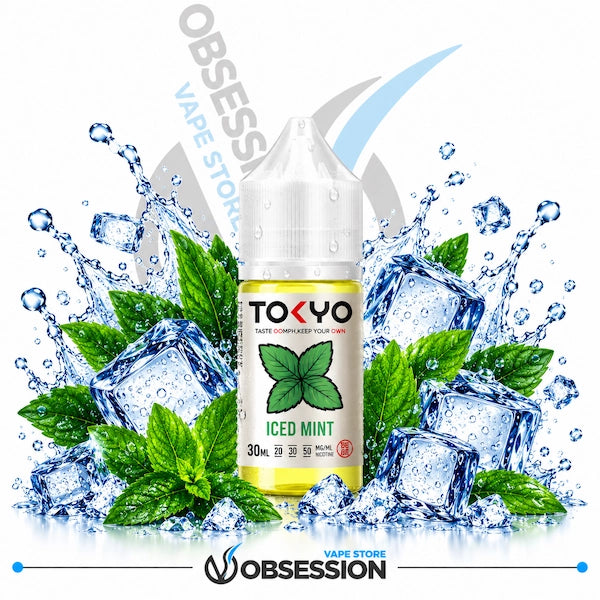 A bottle of Tokyo Vapes Iced Mint e-liquid centered against a white background, surrounded by ice cubes, mint leaves, and water splashes. The bottle label is white with green mint graphics and black text.