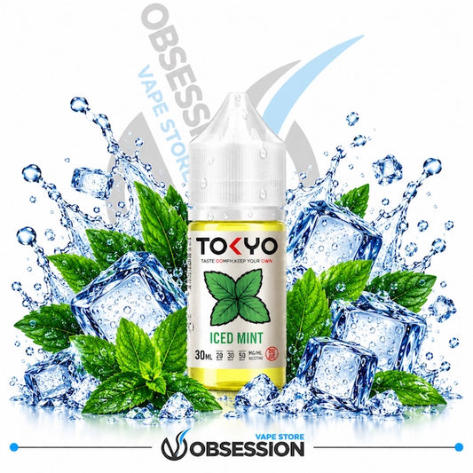 A bottle of Tokyo Vapes Iced Mint e-liquid centered against a white background, surrounded by ice cubes, mint leaves, and water splashes. The bottle label is white with green mint graphics and black text.