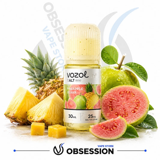 A bottle of Vozol Alt Pineapple Guava e-liquid centered on a white background, surrounded by fresh pineapple slices, a whole pineapple, guava fruit pieces, and green leaves. The bottle label shows the Vozol brand and flavor text.
