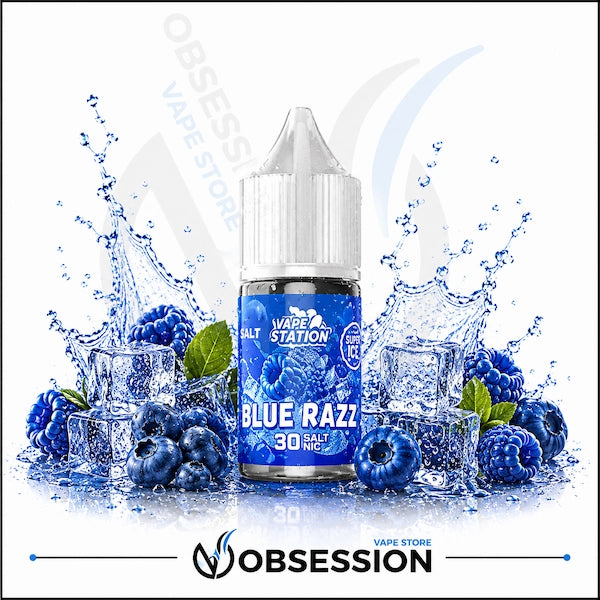 Vape Station Blue Razz Super Ice Salt 30ml.webp shows a Vape Station Blue Razz Super Ice SaltNic vape juice bottle with a clear, droplet-covered cap. The bottle is positioned centrally and surrounded by an intense, ice-cooled arrangement of flavor elements