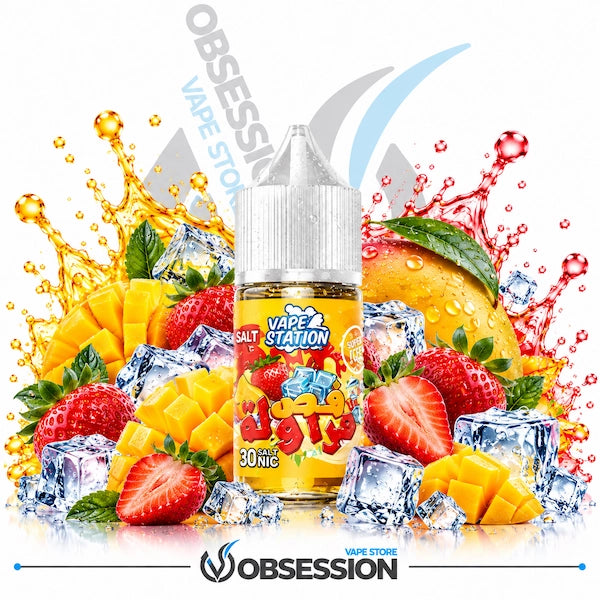 A 30ml bottle of Vape Station Super Ice Fas farawla mango strawberry salt nicotine e-liquid (30mg) with a transparent droplet-covered dropper cap, centered among cross-cut diced mango cubes, a whole ripe mango, whole and sliced fresh strawberries, green leaves, and crystal-clear ice cubes, framed by dynamic golden mango and red strawberry juice splashes over a reflective surface on a white background, featuring a subtle background watermark and the "OBSESSION VAPE STORE" logo along the bottom border.   