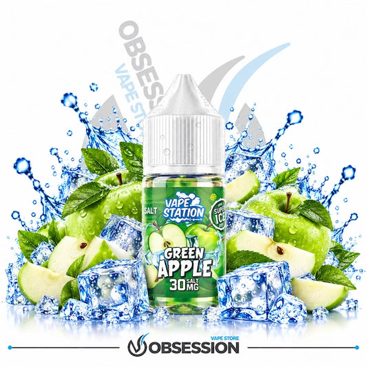 A 30ml bottle of Vape Station Super Ice Green Apple salt nicotine e-liquid (30mg) with a transparent droplet-covered dropper cap, centered among crisp green apples, sliced apple wedges, green leaves, and crystal-clear ice cubes with dynamic water splashes over a reflective surface on a white background, featuring a subtle background watermark and the "OBSESSION VAPE STORE" logo along the bottom border.