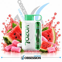A white Vozol vape device with a green mouthpiece and side display, surrounded by watermelon slices, pink candy pieces, and red water splashes on a white background. Obsession Vape Store branding is visible.