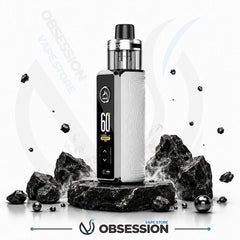 A white and black Obsession vape device with a digital display, standing on a dark stone pedestal surrounded by black rocks and floating metallic spheres on a white background.