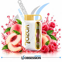 A white Vozol vape device with gold accents and a gold cap, surrounded by fresh peach slices, whole peaches, raspberries, and mint leaves with red liquid splashes. The background is white with Obsession Vape Store branding.